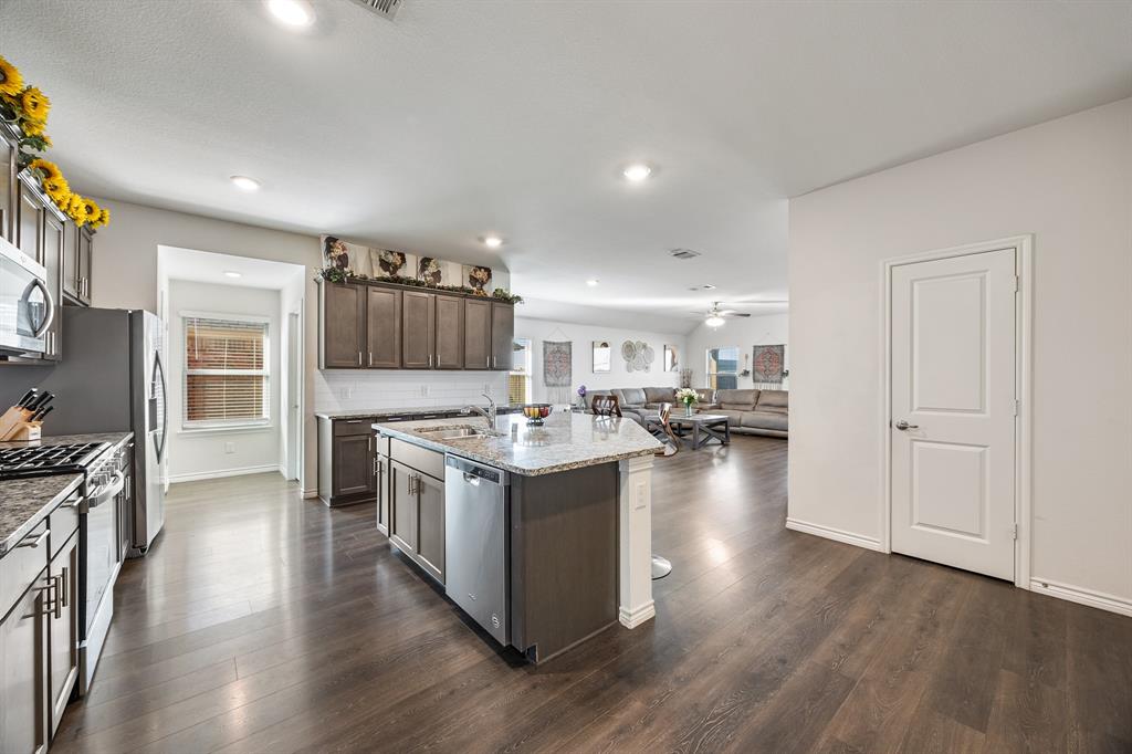 620 Gunsmoke Trail Princeton, TX 75407 - Photo 8 of 37 a kitchen with a stove and a wooden floors