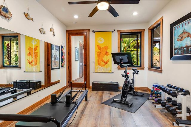 a room with furniture gym equipment and a large window
