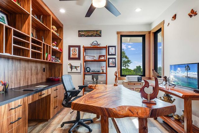 a dining room with stainless steel appliances a large window and table