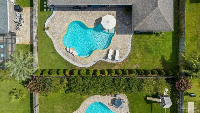 a view of a dining room with furniture a chandelier and wooden floor