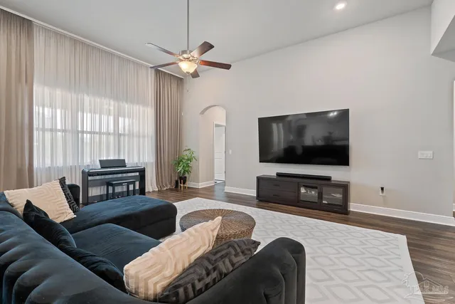 a living room with furniture and a chandelier