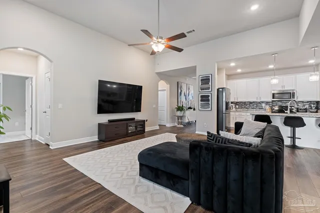 a kitchen with refrigerator cabinets and wooden floor