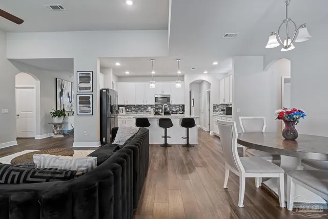 a kitchen with stainless steel appliances kitchen island granite countertop a stove and a refrigerator