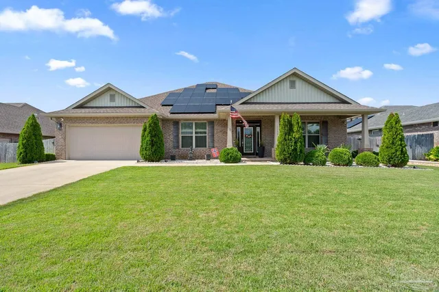 a view of a patio with couches table and chairs under an umbrella