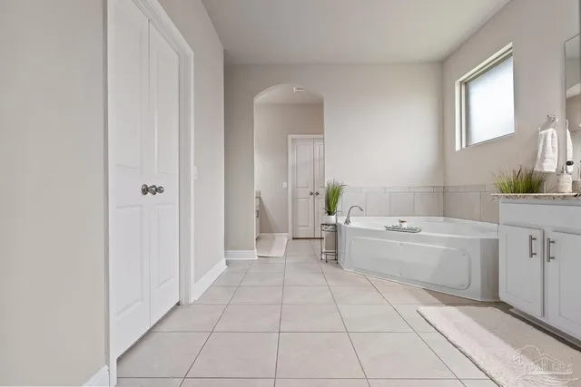 a bedroom with a bed and a flat tv screen in it