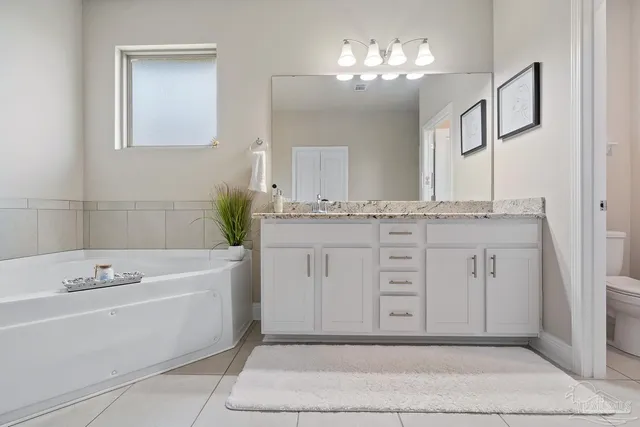 a en suite bathroom with a toilet sink and mirror