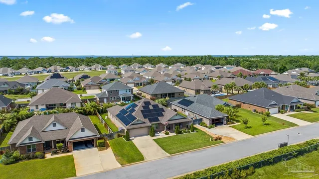 an aerial view of a house with a swimming pool
