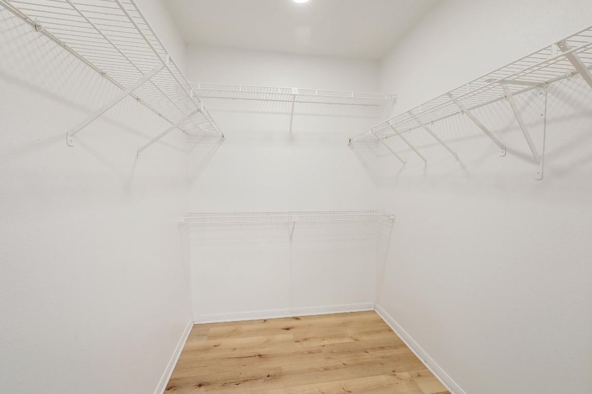 1205 Rambling Trail Cedar Park, TX 78613 - Photo 17 of 38 Primary ensuite walk-in closet featuring Closet Maid wire shelving system and recessed lighting.