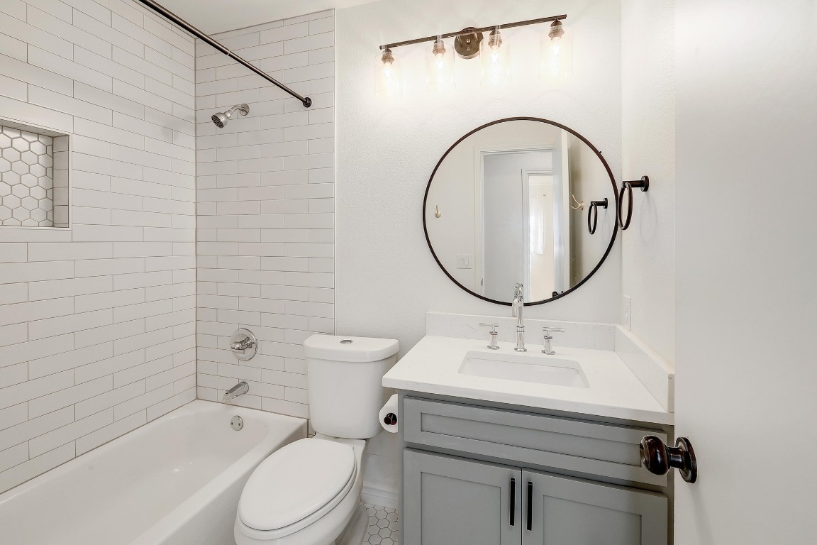 1205 Rambling Trail Cedar Park, TX 78613 - Photo 19 of 38 Full bath between secondary bedrooms featuring vanity and tub/shower combination tiled to the ceiling.