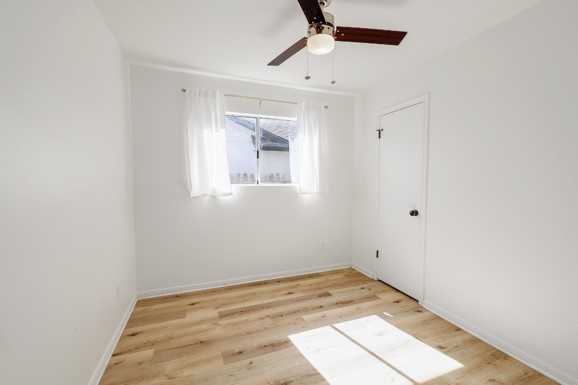 1205 Rambling Trail Cedar Park, TX 78613 - Photo 20 of 38 Bedroom off hallway featuring ceiling fan and walk-in closet.