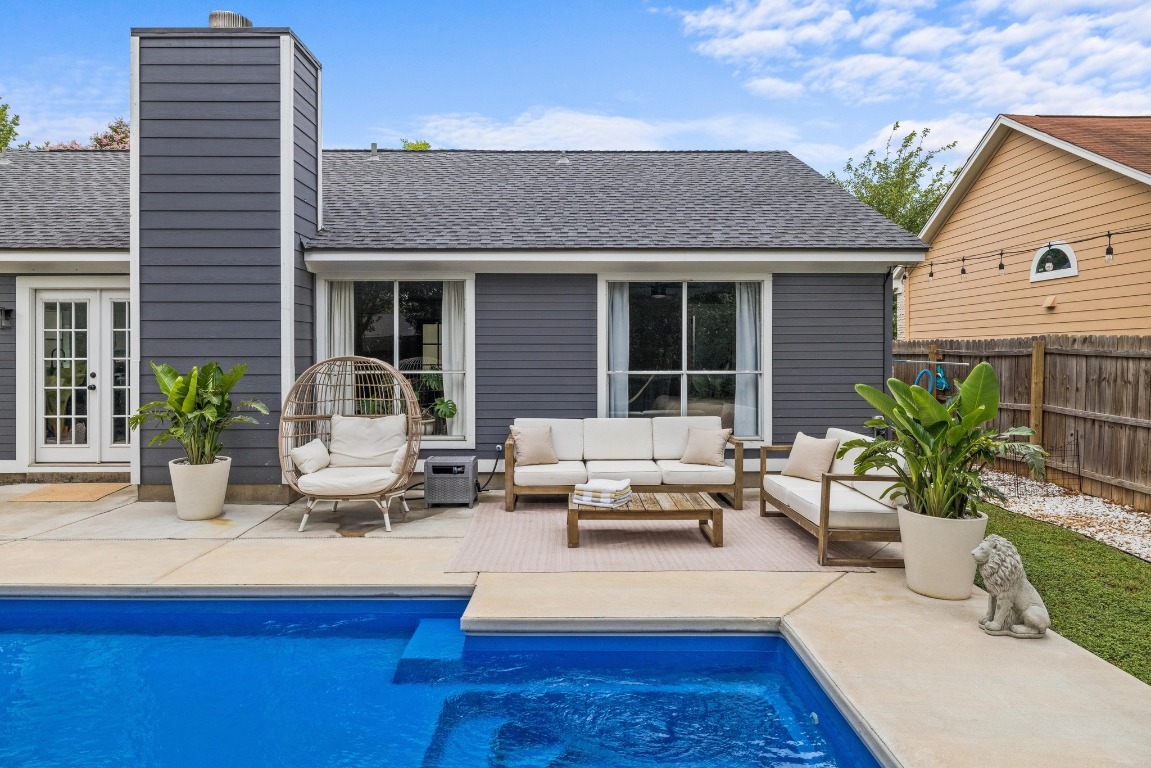 1205 Rambling Trail Cedar Park, TX 78613 - Photo 22 of 38 Rear view of property showcasing shallow end of pool and outdoor lounge area on the patio.