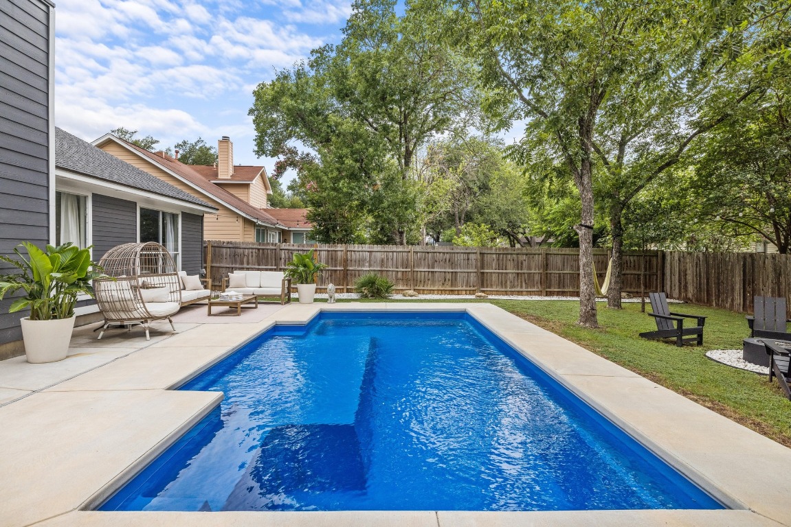 1205 Rambling Trail Cedar Park, TX 78613 - Photo 23 of 38 View of swimming pool from deep end showcasing splash pad, an outdoor living space, fenced backyard, and patio space.