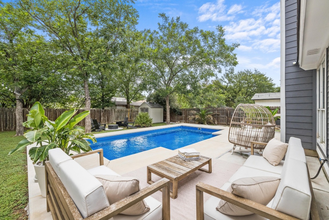 1205 Rambling Trail Cedar Park, TX 78613 - Photo 3 of 38 View of pool with an outdoor living space, a fenced backyard, a storage shed, and a patio area.
