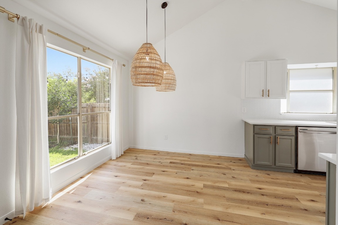 1205 Rambling Trail Cedar Park, TX 78613 - Photo 8 of 38 Dining area with high vaulted ceiling off kitchen. West Elm window treatments with linen curtains.
