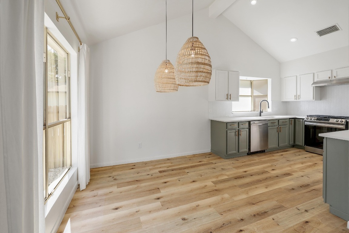 1205 Rambling Trail Cedar Park, TX 78613 - Photo 10 of 38 Kitchen with beamed and high vaulted ceiling, bay window, and recessed lighting.