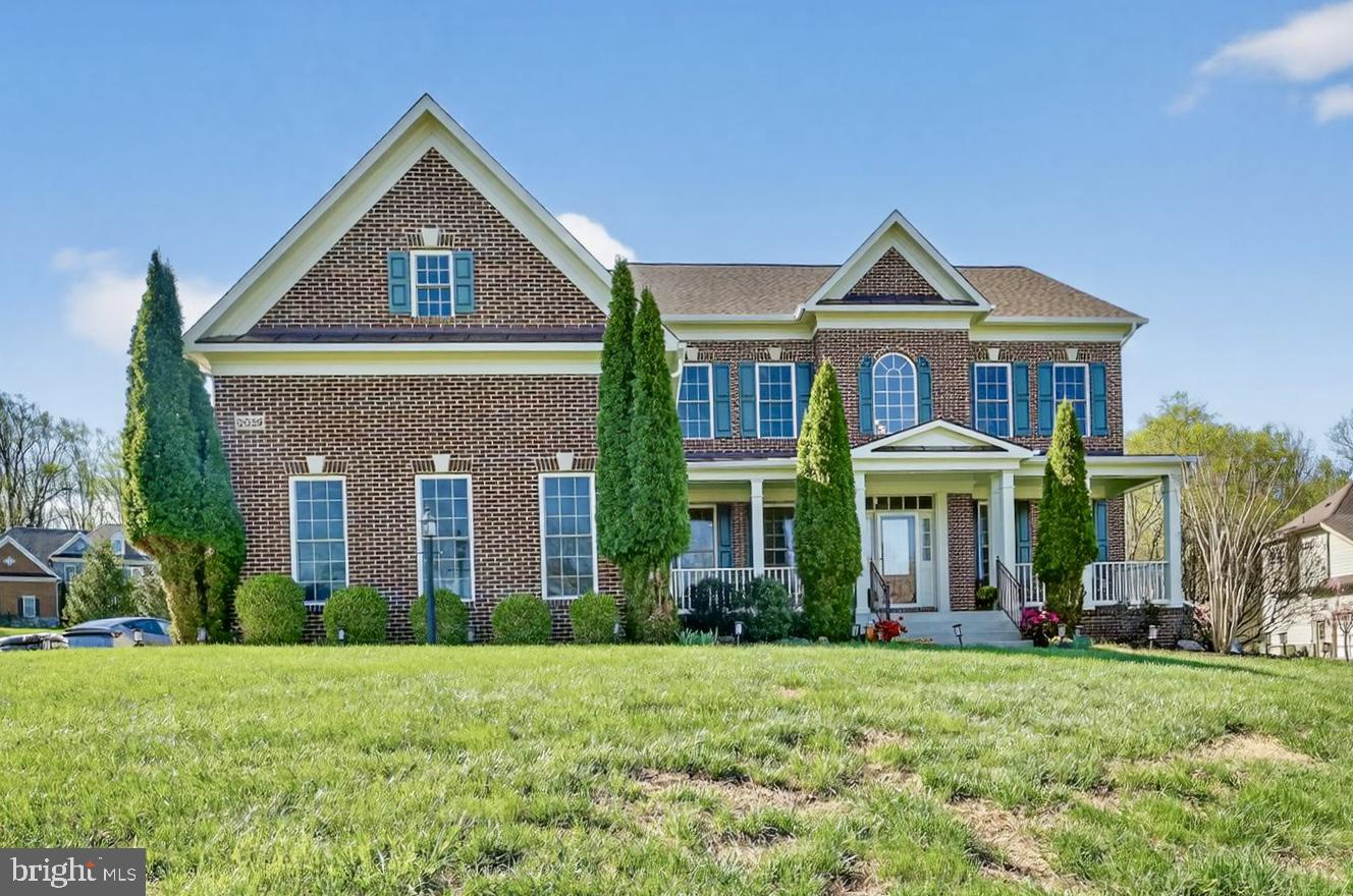 Elegant brick home with lush greenery.