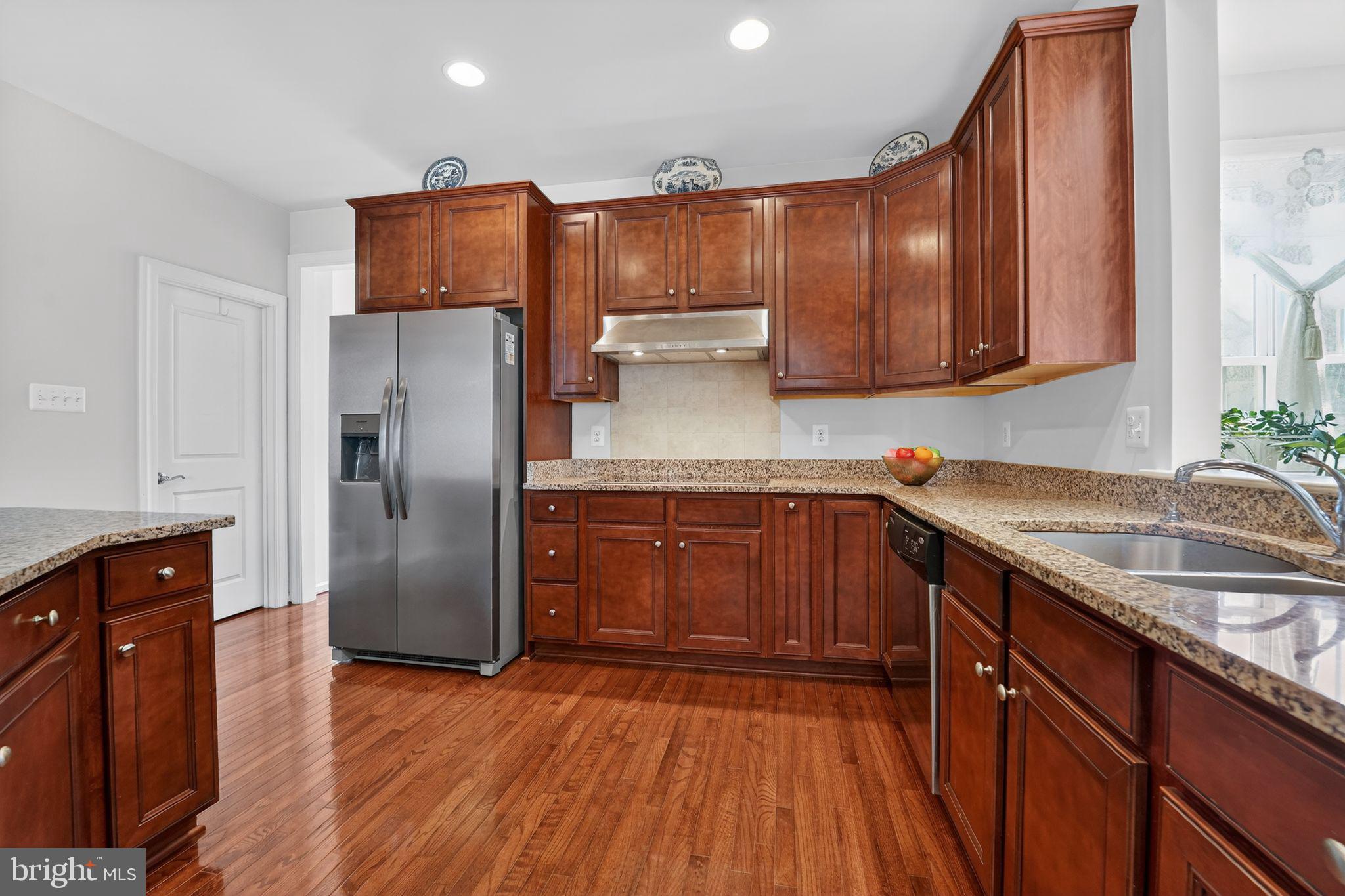 12039 Open Run Road Ellicott City, MD 21042 - Photo 25 of 67 Warm wood tones in a modern kitchen.