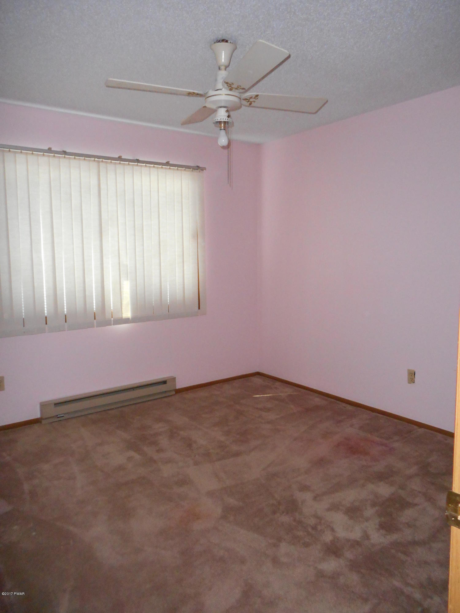 262 High Ridge Road Dingmans Ferry, PA 18328 - Photo 15 of 21 an empty room with a ceiling fan and window
