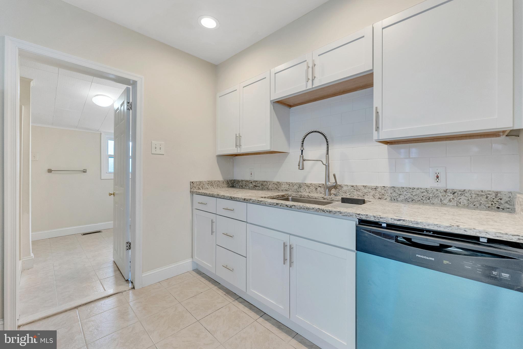 114 Delaware Avenue Riverside, NJ 08075 - Photo 6 of 21 a kitchen with granite countertop a sink stainless steel appliances and cabinets