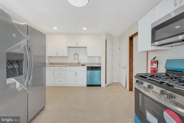 a view of an empty room with window and cabinet
