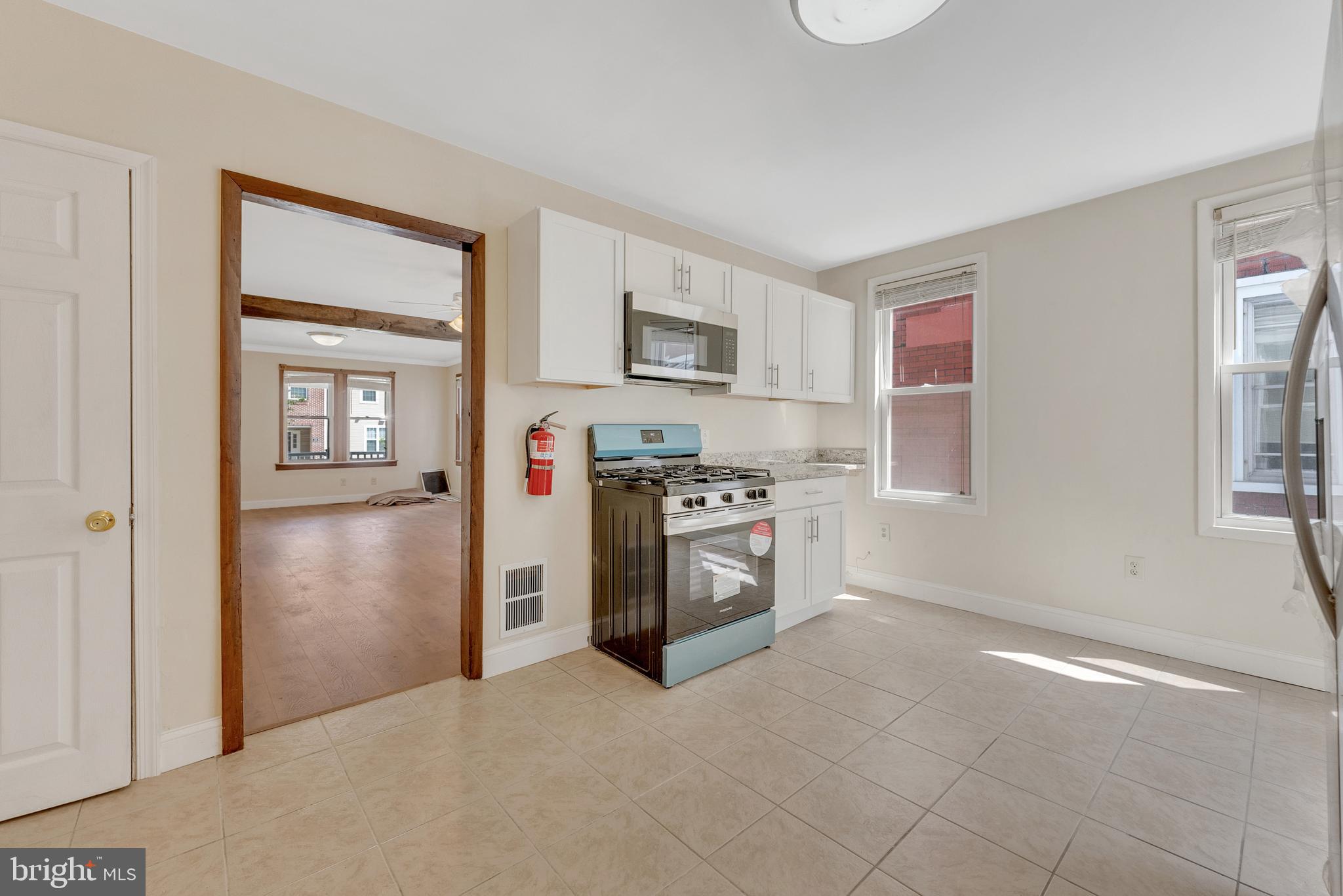 114 Delaware Avenue Riverside, NJ 08075 - Photo 9 of 21 a kitchen with stainless steel appliances granite countertop a refrigerator and a stove top oven