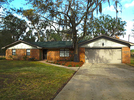 1562 Bay Grove Road Freeport, FL 32439 - Photo 1 of 18 a front view of a house with a yard and garage