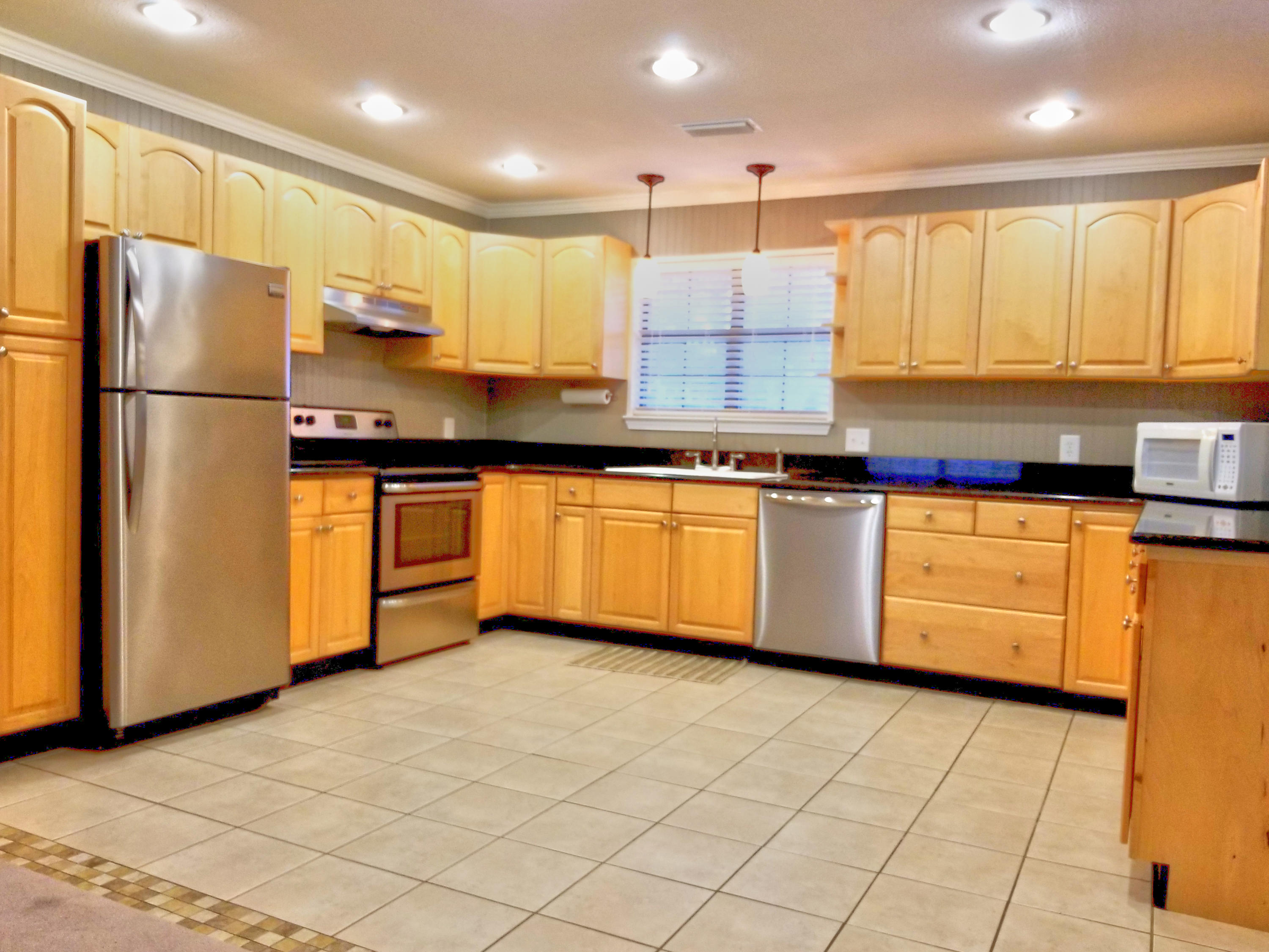 1562 Bay Grove Road Freeport, FL 32439 - Photo 2 of 18 a kitchen with stainless steel appliances granite countertop a stove a sink and a refrigerator