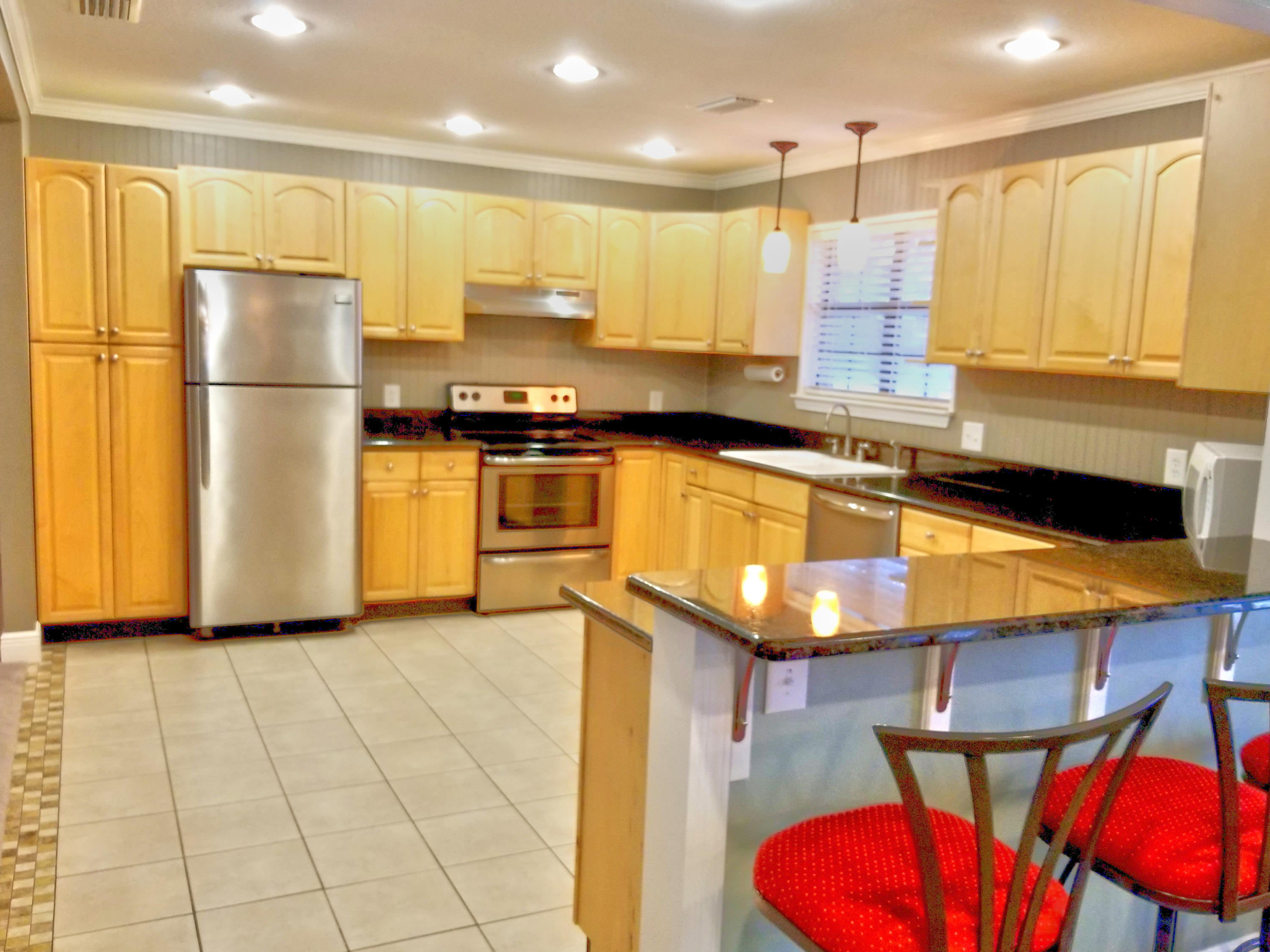 1562 Bay Grove Road Freeport, FL 32439 - Photo 4 of 18 a kitchen with stainless steel appliances granite countertop a sink refrigerator and cabinets