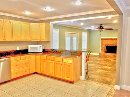 1562 Bay Grove Road Freeport, FL 32439 - Photo 5 of 18 a large kitchen with granite countertop a sink and cabinets