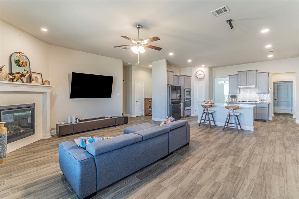 10638 Cherry Tree Way Grand Prairie, TX 76065 - Photo 3 of 39 Spacious living room with electric fireplace facing large kitchen island