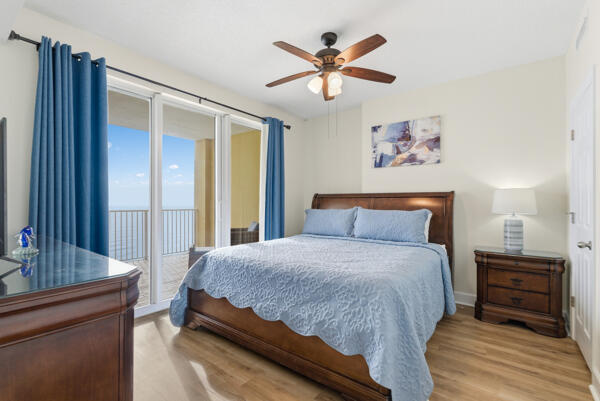 17643 Front Beach Road, Unit 1806 Panama City Beach, FL 32413 - Photo 11 of 25 a bedroom with a bed and a chandelier
