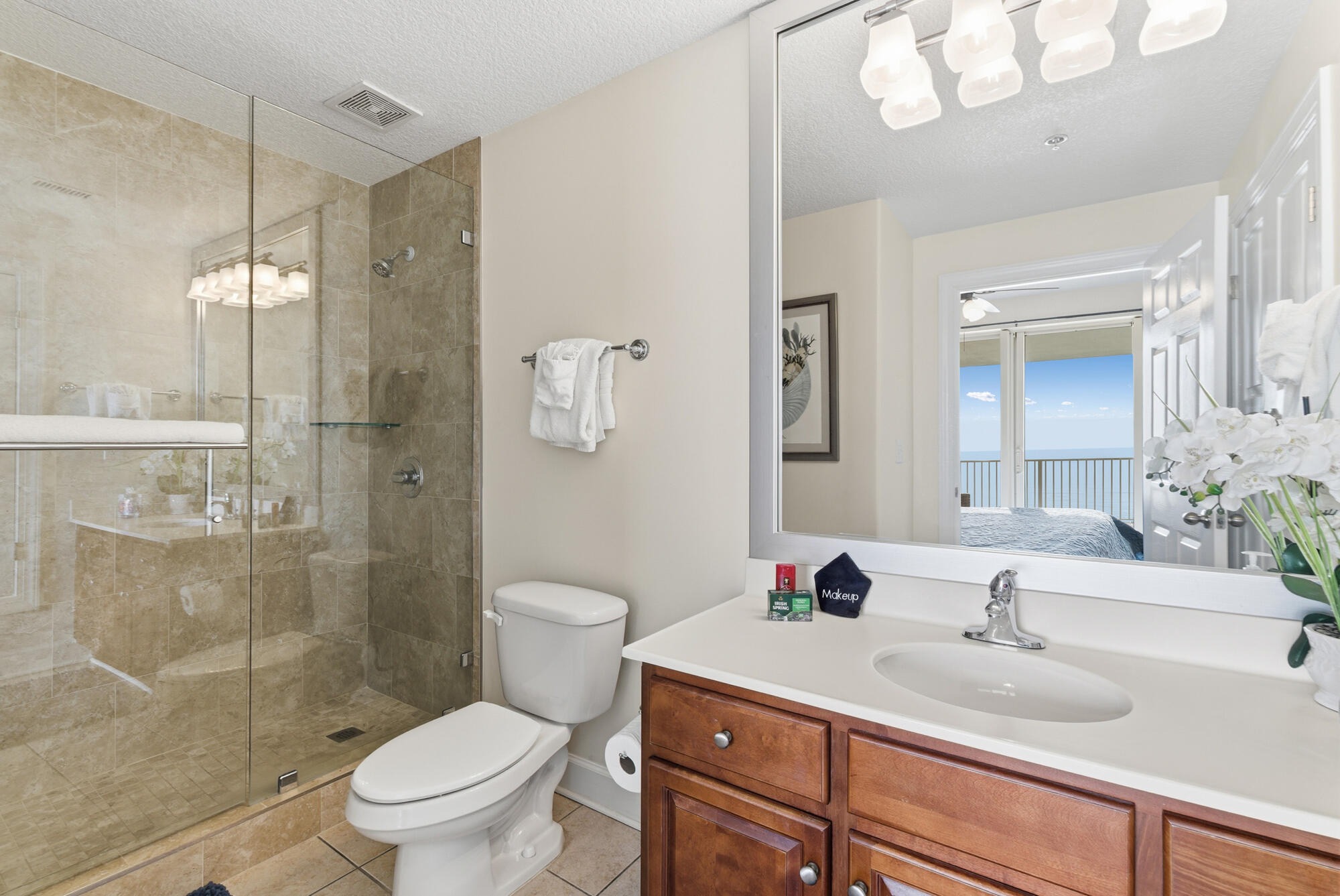 17643 Front Beach Road, Unit 1806 Panama City Beach, FL 32413 - Photo 12 of 25 a bathroom with a sink a toilet and shower