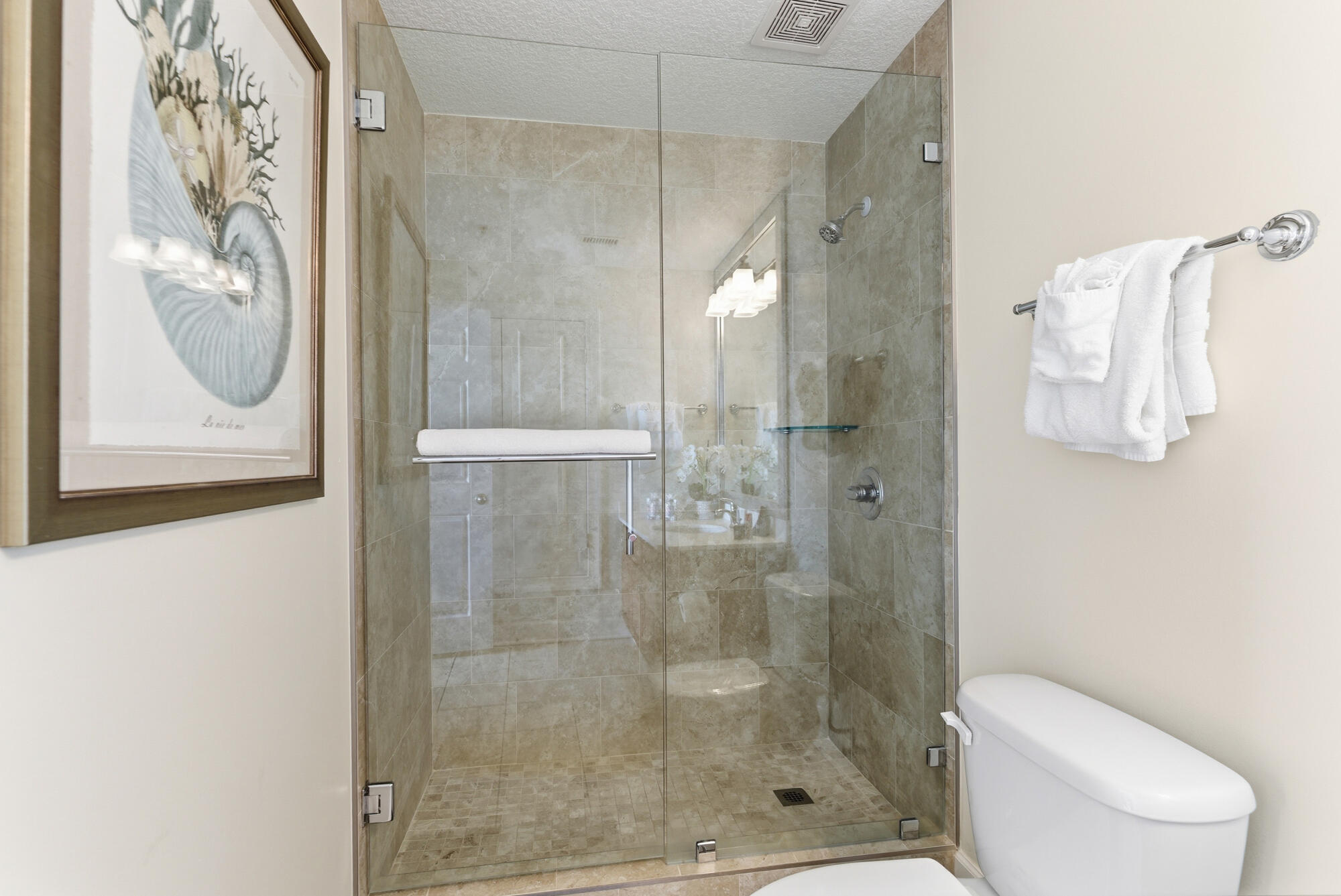 17643 Front Beach Road, Unit 1806 Panama City Beach, FL 32413 - Photo 13 of 25 a bathroom with a shower and toilet