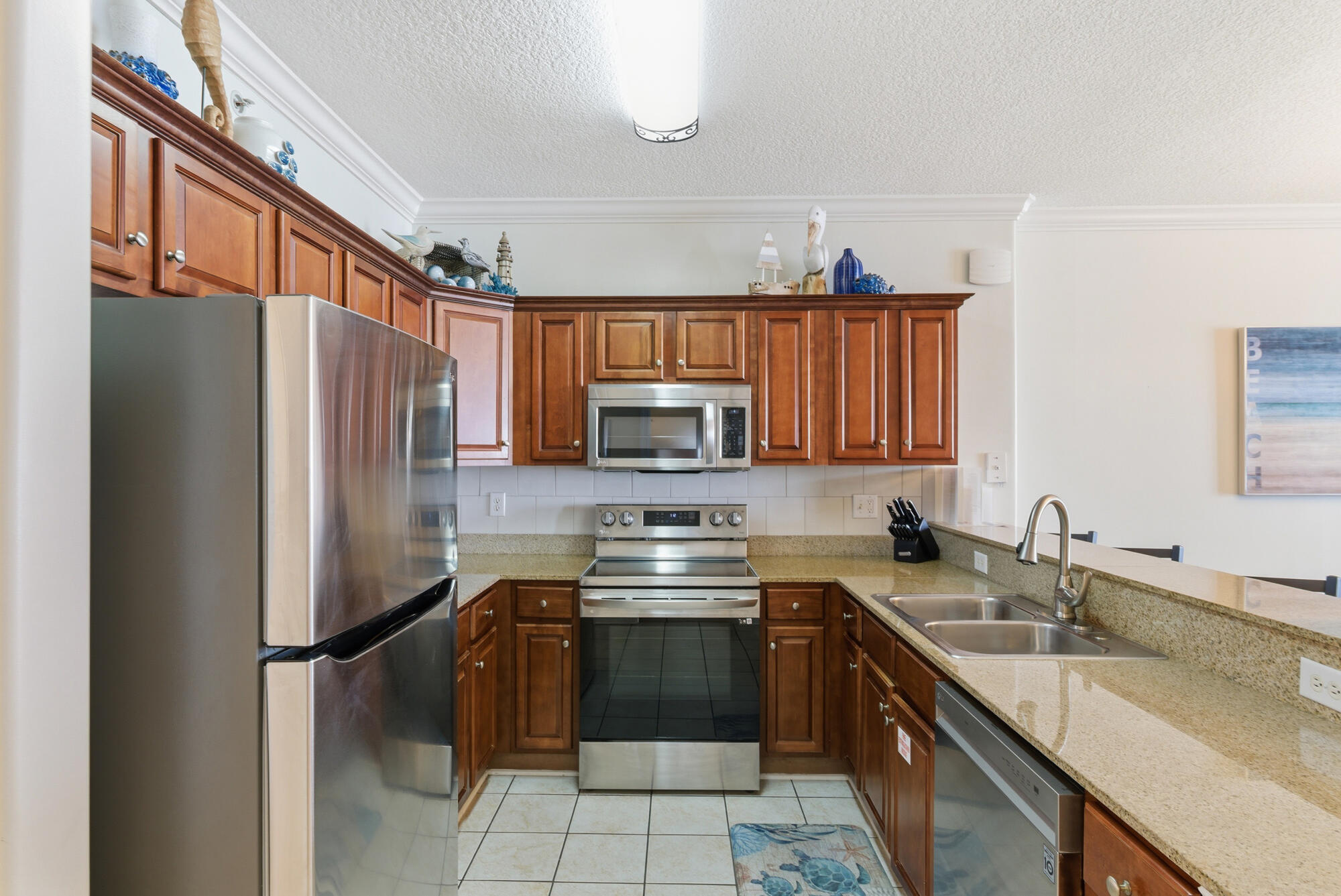 17643 Front Beach Road, Unit 1806 Panama City Beach, FL 32413 - Photo 16 of 25 a kitchen with a sink appliances and cabinets