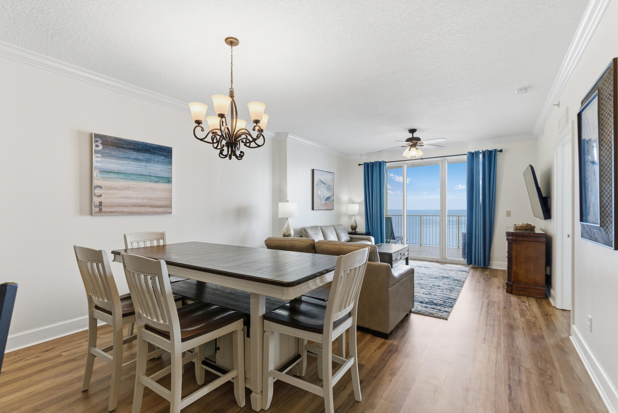 17643 Front Beach Road, Unit 1806 Panama City Beach, FL 32413 - Photo 19 of 25 a view of a dining room with furniture window and wooden floor