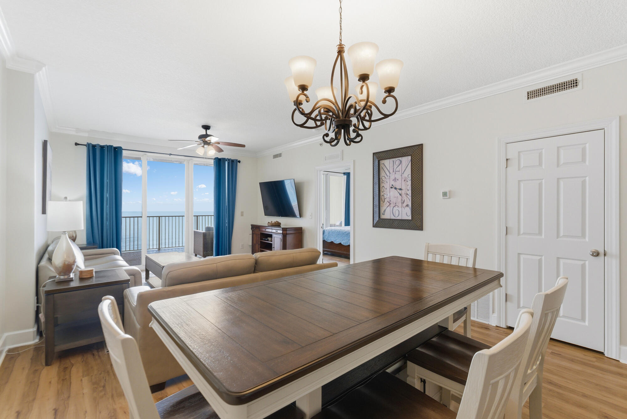 17643 Front Beach Road, Unit 1806 Panama City Beach, FL 32413 - Photo 20 of 25 a view of a dining room with furniture wooden floor and chandelier