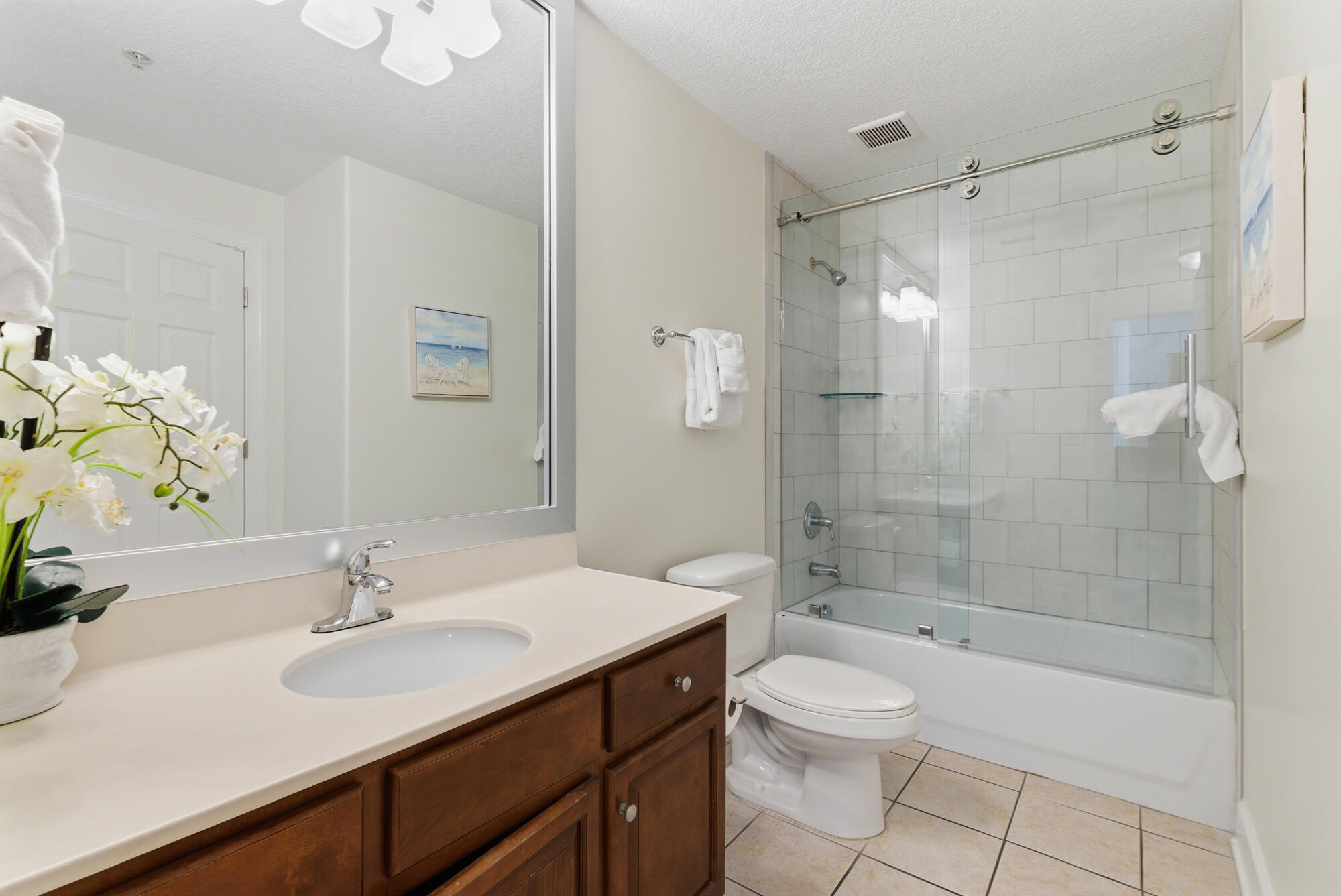 17643 Front Beach Road, Unit 1806 Panama City Beach, FL 32413 - Photo 23 of 25 a bathroom with a sink a toilet and shower
