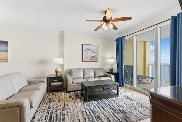 a living room with furniture a large window and a flat screen tv