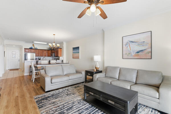 17643 Front Beach Road, Unit 1806 Panama City Beach, FL 32413 - Photo 5 of 25 a living room with furniture and a wooden floor