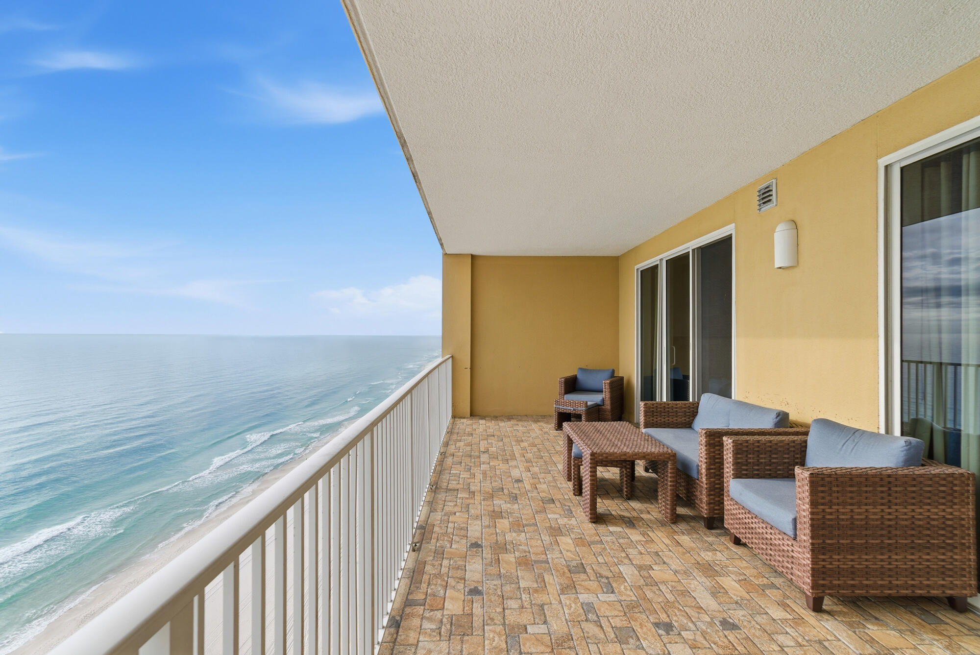 17643 Front Beach Road, Unit 1806 Panama City Beach, FL 32413 - Photo 7 of 25 a balcony with furniture and a table