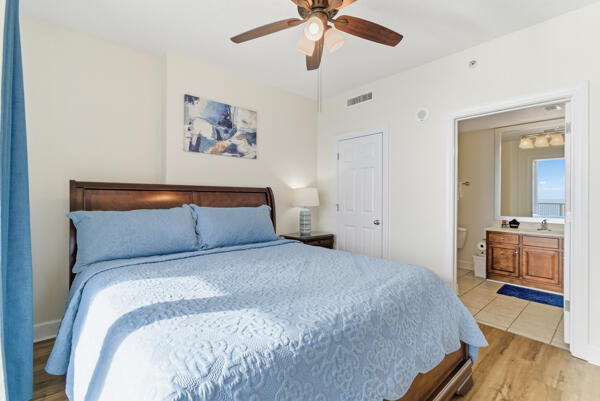 17643 Front Beach Road, Unit 1806 Panama City Beach, FL 32413 - Photo 9 of 25 a bedroom with a bed and a chandelier
