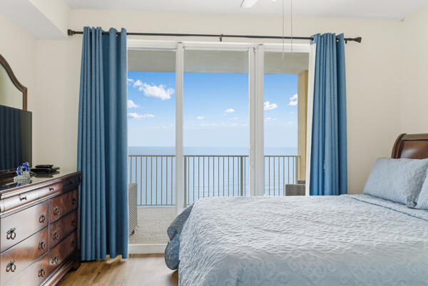 17643 Front Beach Road, Unit 1806 Panama City Beach, FL 32413 - Photo 10 of 25 a bedroom with a bed and a flat tv screen on dresser