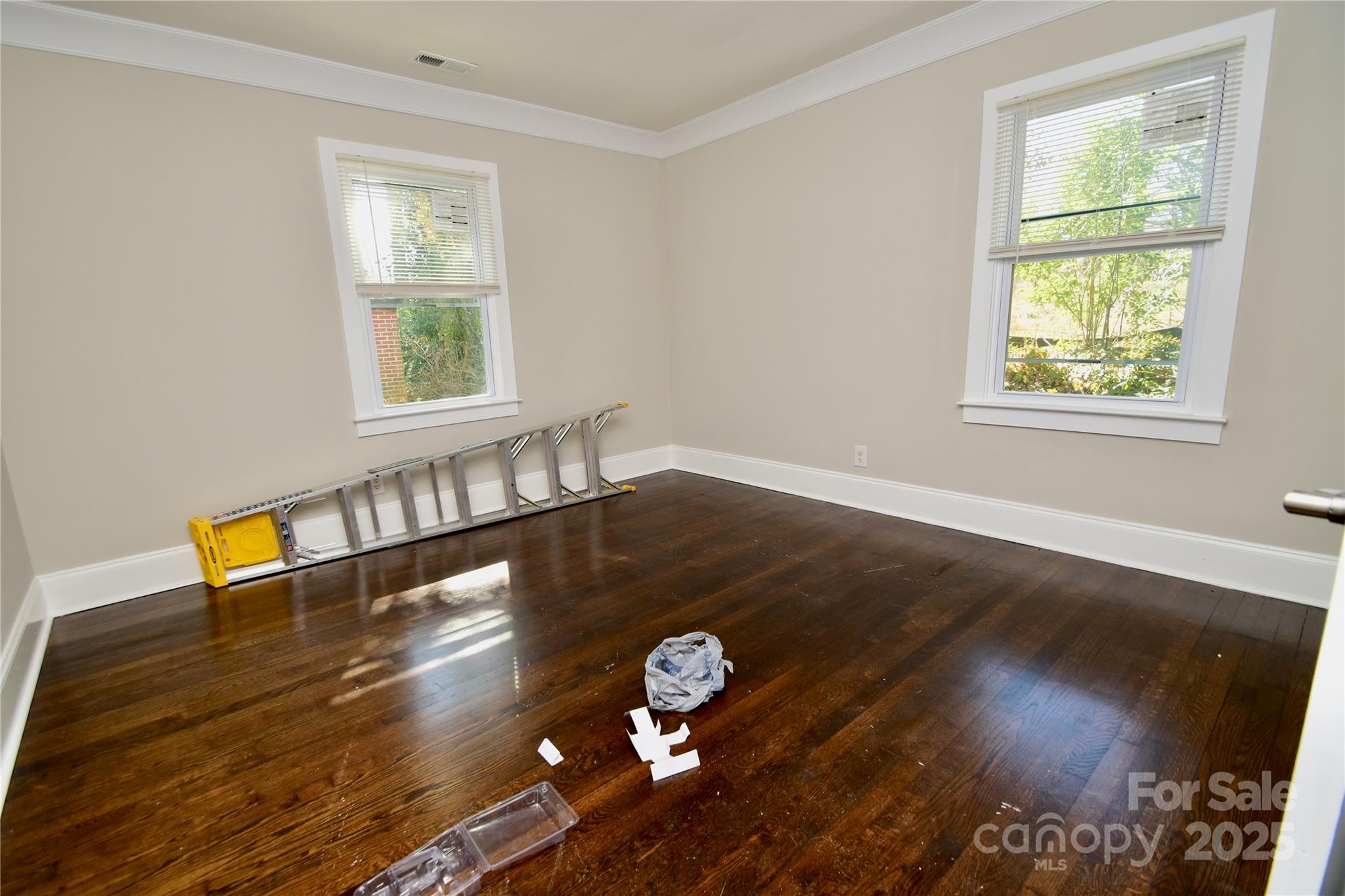 506 East Ridge Street Kings Mountain, NC 28086 - Photo 14 of 23 an empty room with wooden floor and windows