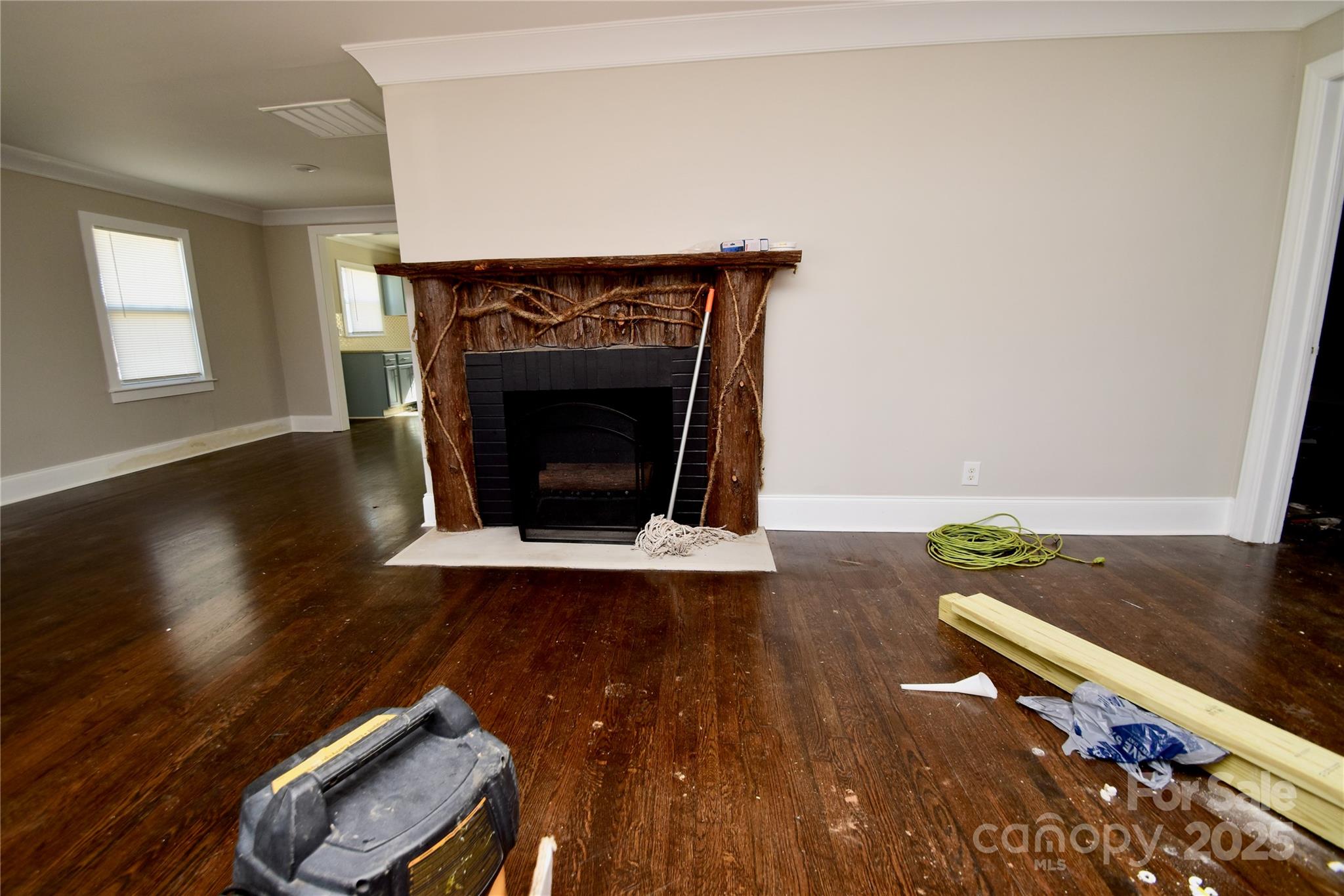506 East Ridge Street Kings Mountain, NC 28086 - Photo 3 of 23 an empty room with wooden floor fire place and windows