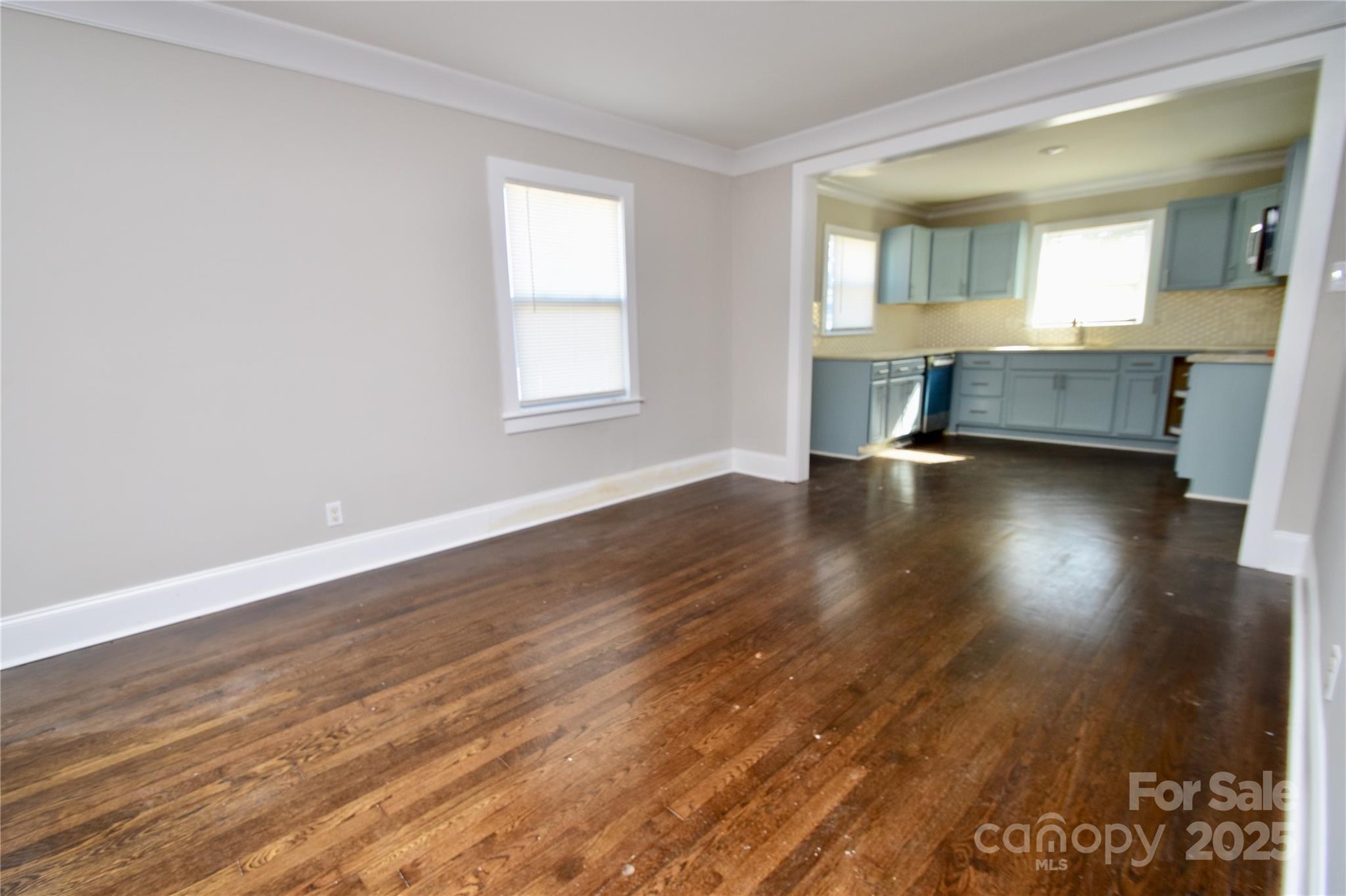 506 East Ridge Street Kings Mountain, NC 28086 - Photo 7 of 23 an empty room with wooden floor and windows