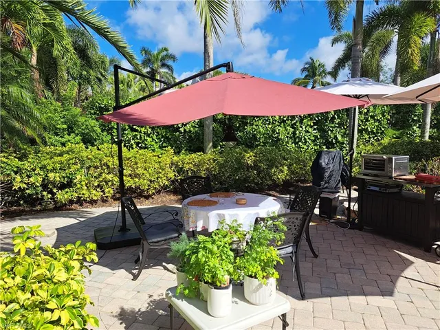 a view of a patio with table and chairs potted plants