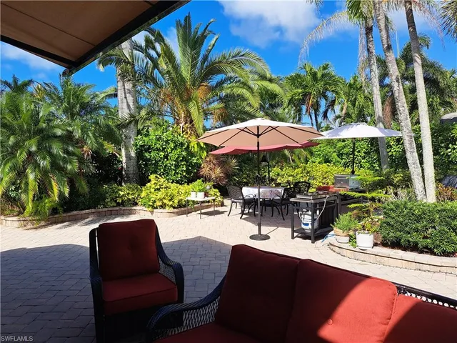 a view of a backyard with sitting area and furniture