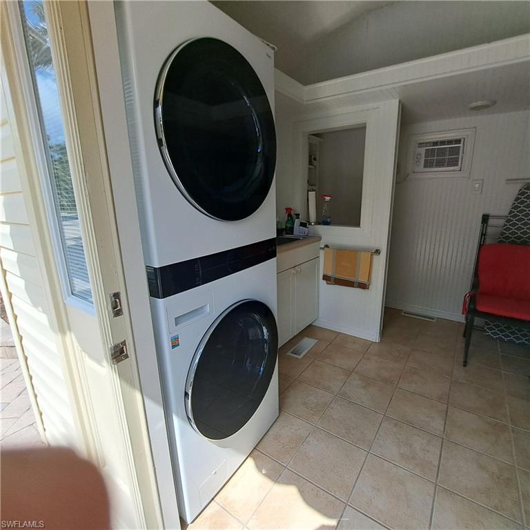 4928 Coach Lane Naples, FL 34114 - Photo 16 of 20 a view of a hallway with washer and dryer