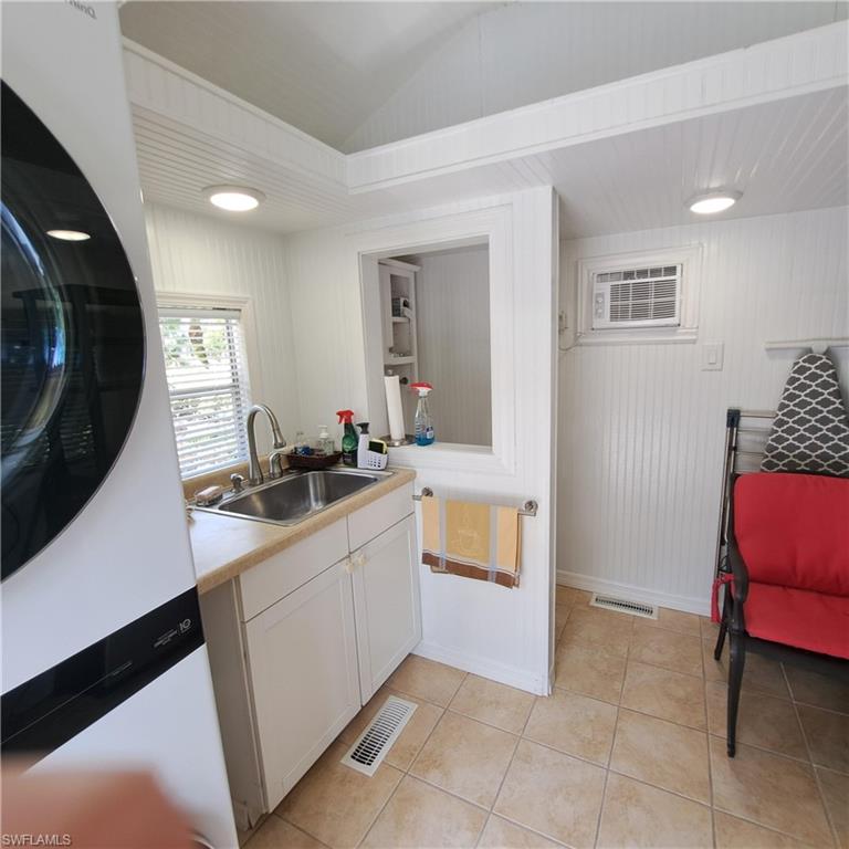 4928 Coach Lane Naples, FL 34114 - Photo 18 of 20 a kitchen with a sink and a stove top oven