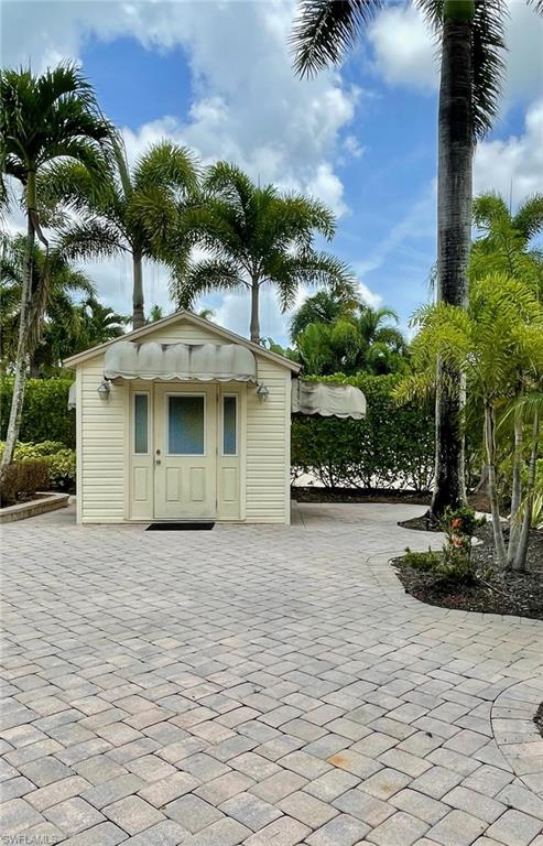 4928 Coach Lane Naples, FL 34114 - Photo 7 of 20 a front view of a house with a yard and garage